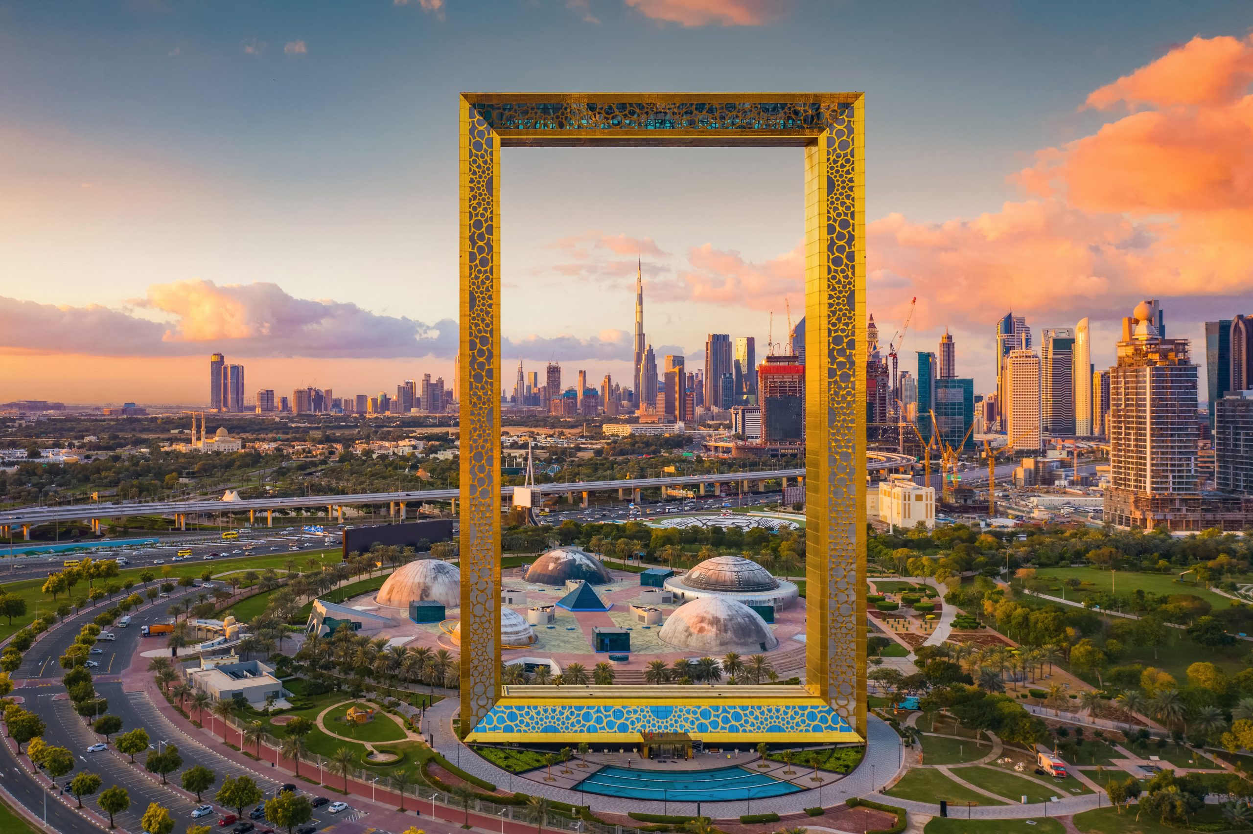 Aerial view of Dubai Frame, Downtown skyline, United Arab Emirates or UAE. Financial district and business area in smart urban city. Skyscraper and high-rise buildings at sunset.